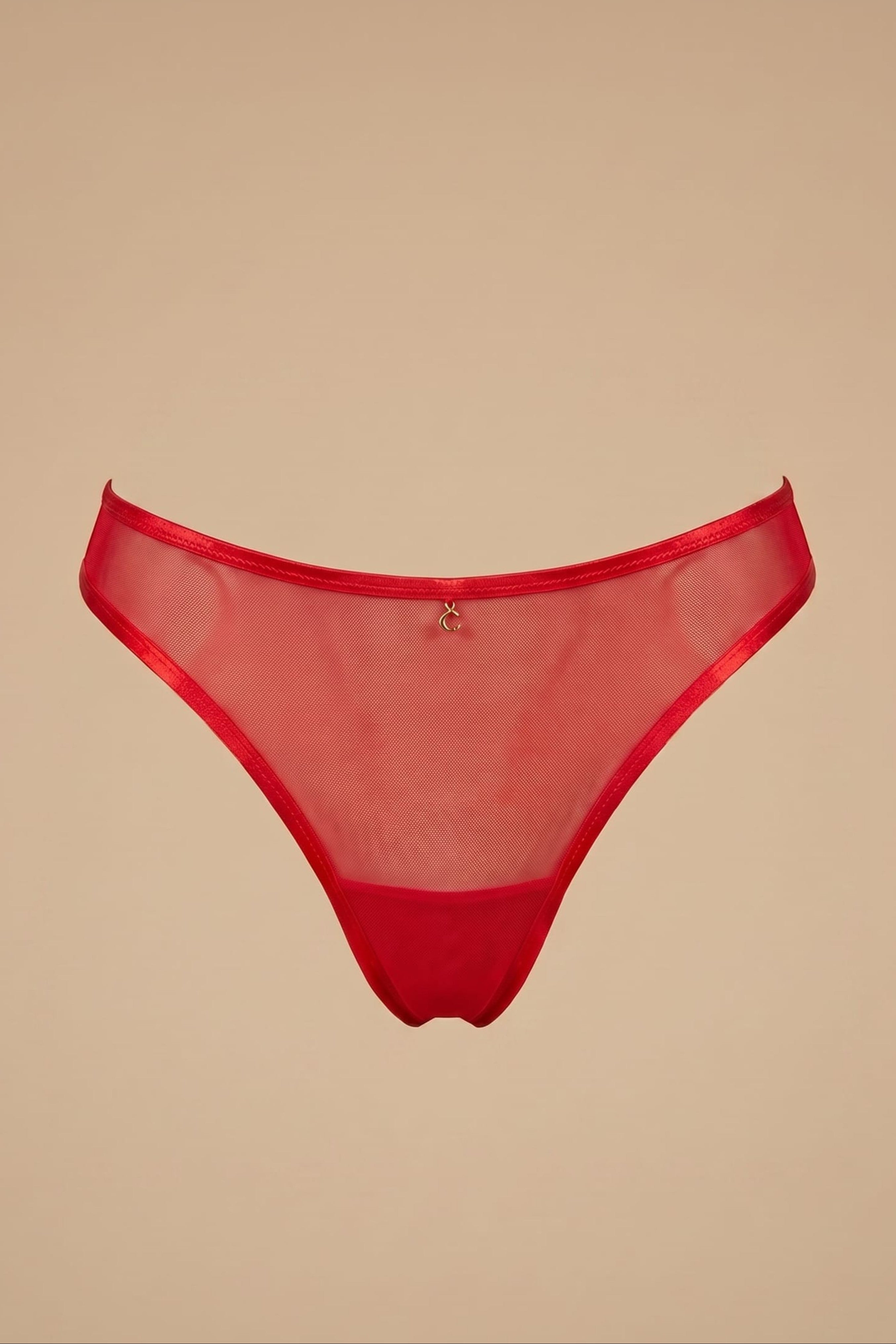 Red mesh thong on a beige background
